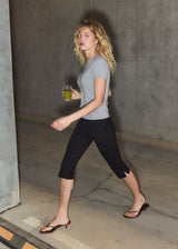 Black capri pants in a soft jersey material. Tanny capri pants has an elastic waistband and a slit with a zipper. The model is 175 cm and wears a size S/36.