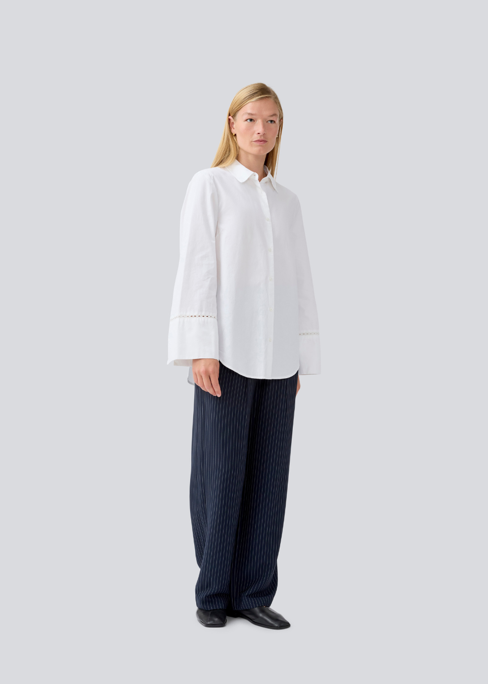 Oversize shirt with broderie anglaise details. MallenMD shirt has long wide sleeves with slits, shirtcollar and a button closure in front.