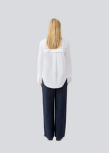 Oversize shirt with broderie anglaise details. MallenMD shirt has long wide sleeves with slits, shirtcollar and a button closure in front.