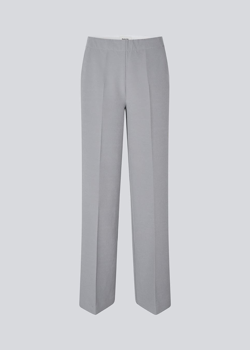 Classic pants in grey with pressfolds and straight legs. Nelli pants are closed by an hidden zipper at the side with an elastic waistband for a more comfortable fit. 