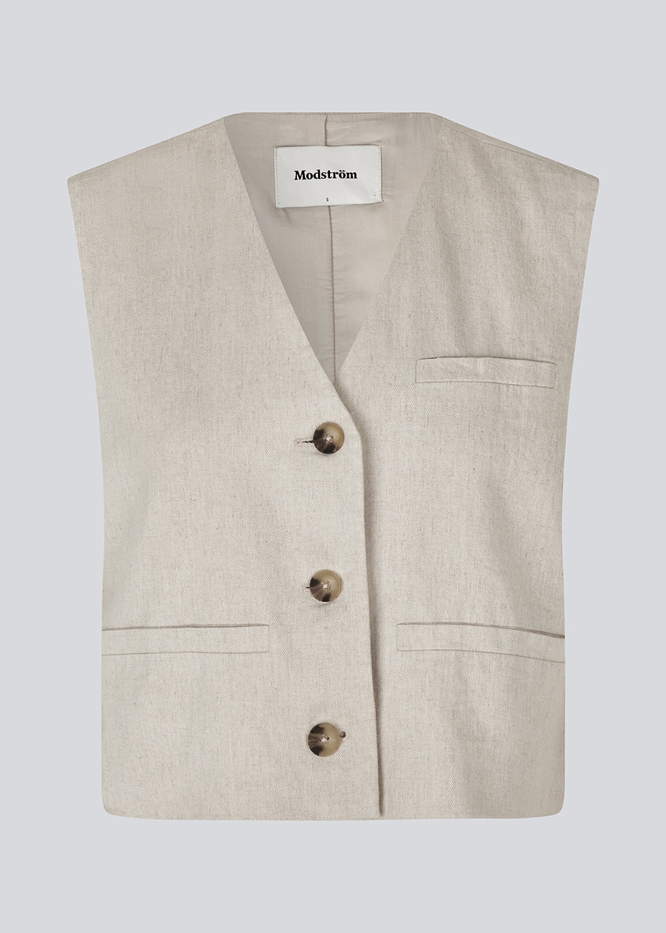 Short beige waistcoat in a woven linen blend in beige. ParkMD vest has a deep v-neck with buttons and a relaxed and loose silhouette. 