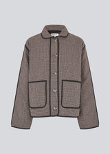 Quilted jacket with a loose fit. Ominemd jacket has a shirt collar, button closure, and two front pockets. 