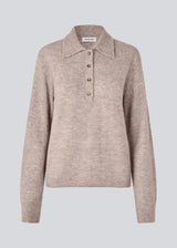 Knitted polo in beige with long sleeves. Treemd polo has a placket closure and 4 buttons. 
