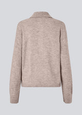 Knitted polo in beige with long sleeves. Treemd polo has a placket closure and 4 buttons. 