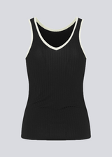 Tight-fitted black sleeveless top in a stretchy material with a round neck cutting lower on the back. FaizMD top has contrasting bias tape.