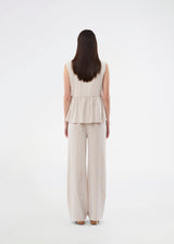 Feminine vest top with a gathered, loose hem. The AgneteMD Vest is sleeveless with a V-neckline and a simple button closure. Can be styled alone or layered for a modern and versatile look.
