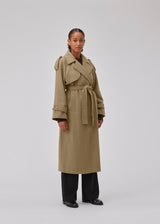 Coat in Dune in trenchcoat style with an oversized silhouette. BorakMD coat is double-breasted with a collar, open yoke, belt at the waist, and a slit in the back. Woolen quality. Lined.