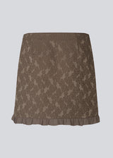 Elegant and feminine short skirt in luxurious fabric with beautiful texture and pattern. The Briannamd Skirt features a flattering A-line silhouette with decorative ruffle trim and a discreet zip closure. Made from 100% recycled polyester.
