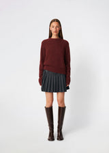 Pleated mini skirt with a modern, preppy aesthetic. Cirkelinemd skirt features a low-rise waist with a wrap-inspired design, decorative strap detail, and crisp pleats that create beautiful movement and volume. The mini length and tailored silhouette make it a versatile piece for both everyday styling and more elevated occasions. Pair it with a shirt, knitwear, or a simple top for a timeless look.