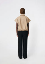 Short vest with a modern, relaxed aesthetic. Cleamd vest features a boxy silhouette with short, wide sleeves, a classic collar, and snap button closure at the front. Discreet front pockets and an elasticated hem create a soft, rounded shape and a comfortable fit. Perfect for layering over knitwear, shirts, or dresses during the transitional seasons.