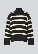 Fine-knitted oversized jumper knitted from cotton in black with beige stripes. CorbinMD stripe t-neck has a ribbed rollneck, long wide sleeves, and wide ribbing at cuffs and hem.  The model is 177 cm and wears a size S/36.