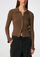 Feminine rib-knit cardigan with elegant details. Corneliamd cardigan is designed in a fitted silhouette with a classic collar, full button-front closure, and delicate ruffle trims at the cuffs. The soft rib-knit enhances the flattering fit, making it a versatile wardrobe staple that can be worn buttoned up as a knit top or layered open over a camisole or dress.