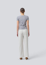 Tight fit basic top with a high and straight neckline in grey. DaeMD top is made from a rib-knit organic cotton. The model is 177 cm and wears a size S/36.