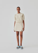 Short skirt with a medium waistline. DaynaMD skirt is made with a slim fit with wrap-over detail with a small slit in front and zipper at the side. The model is 177 cm and wears a size S/36.