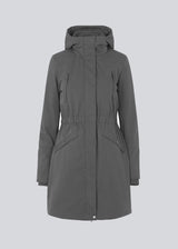 Denise coat in grey has a hood, fitted at the waist and has hidden zipper closure at front. The jacket has 4 pockets and is lined with Thermolite polyester padding, which is recognized for its high insulation and therefore is the perfect choice for the cold winters.