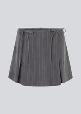 Short skirt in grey pinstripe with bows and box pleats. EmiliaMD bow skirt has an invisible zipper at the back and a cute bow detail in front.<br>