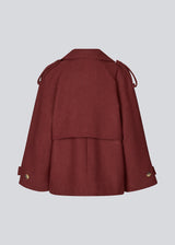 Cropped double-breasted wool coat in burgundy/dark red with hidden buttons. EsmundMD jacket has classic coat details with raglan sleeves and a high yoke at the back. Lined. 