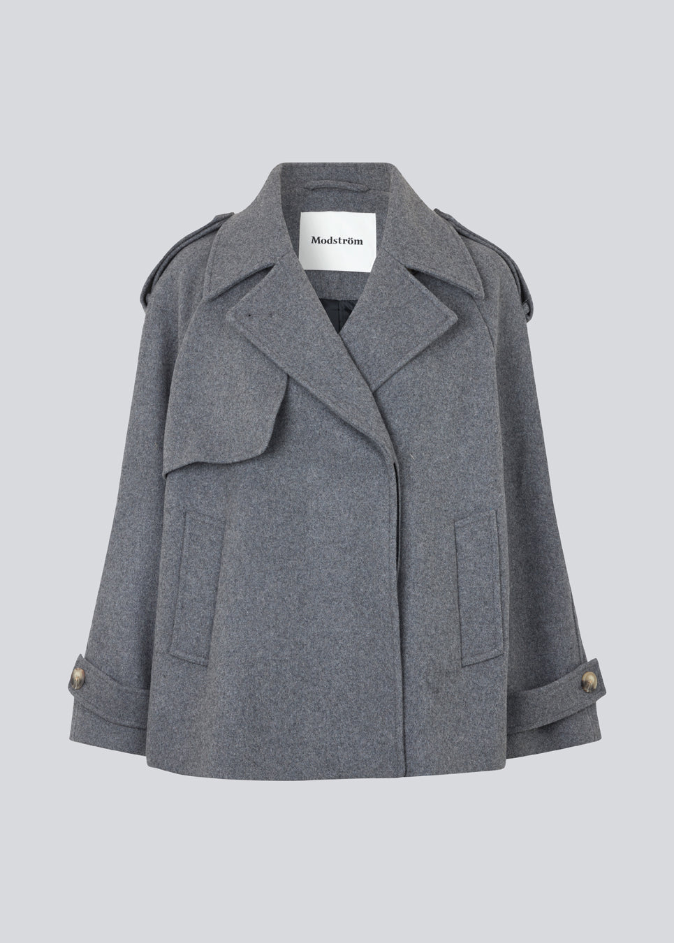 Cropped double-breasted wool coat with hidden buttons. EsmundMD jacket, in the colot Dark Grey Melange, has classic coat details with raglan sleeves and an high yoke at the back. Lined. The model is 175 cm and wears a size S/36.