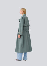 Oversized double-breasted trenchcoat with tie belt at the waist. EvieMD jacket has dropped shoulders and long, wide sleeves. Lined.
