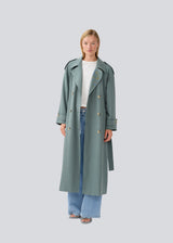 Oversized double-breasted trenchcoat with tie belt at the waist. EvieMD jacket has dropped shoulders and long, wide sleeves. Lined.