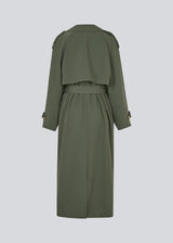 Oversized double-breasted trench coat in dark green with a tie belt at the waist. EvieMD jacket has dropped shoulders and long, wide sleeves. Lined. 