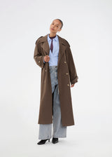 Oversized double-breasted trench coat in dark brown with tie belt at the waist. EvieMD jacket has dropped shoulders and long, wide sleeves. Lined. 