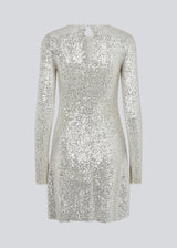 Short dress with sequins. FannieMD dress has a slim silhouette with a round neck and long sleeves, along with a keyhole opening at the back with a button for closure. The model is 175 cm and wears a size S/36.