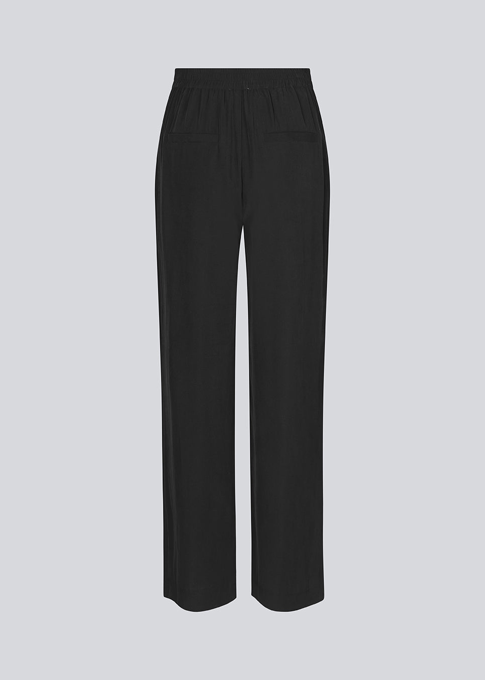 FanyaMD pants in black have a menswear-inspired look with straight, wide legs, a high waist with zip fly and button and elastication in back. Doubble pleat in front and side pockets.