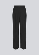 FanyaMD pants in black have a menswear-inspired look with straight, wide legs, a high waist with zip fly and button and elastication in back. Doubble pleat in front and side pockets.