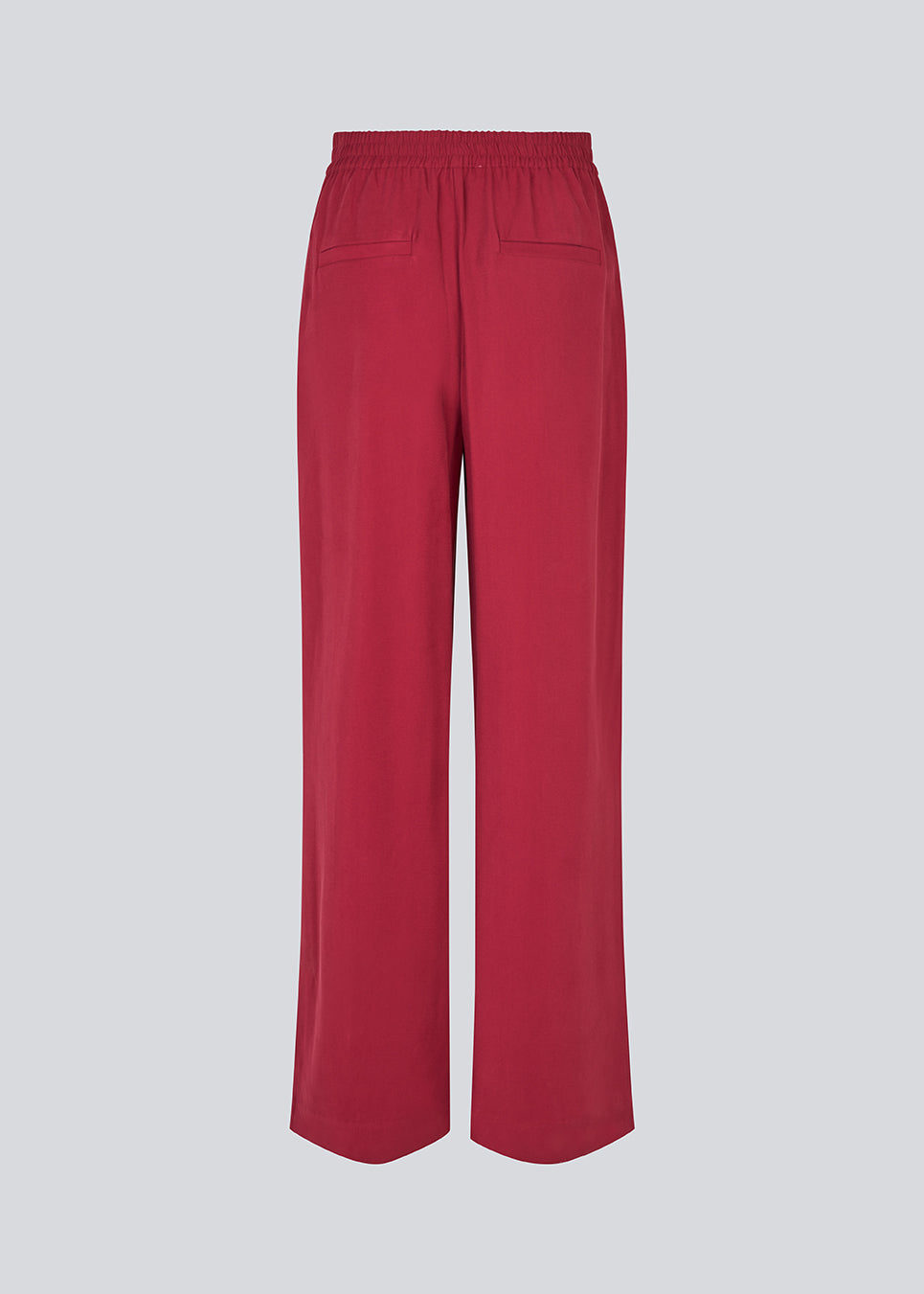 FanyaMD pants have a menswear-inspired look with straight, wide legs, a high waist with zip fly and button and elastication in back. Doubble pleat in front and side pockets. The model is 175 cm and wears a size S/36.