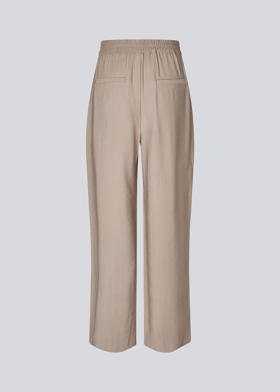 FanyaMD pants have a menswear-inspired look with straight, wide legs, a high waist with zip fly and button and elastication in back. Doubble pleat in front and side pockets.