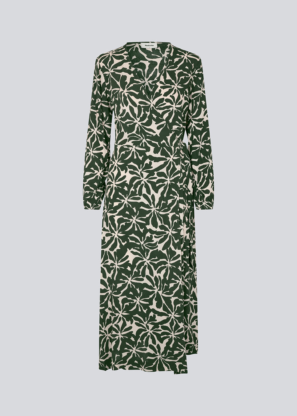 Midi dress in printed EcoVero viscose with v-neckline and wrap detail in front. FernMD print wrap dress has a wide tie belt at the waist and long balloon sleeves. The model is 175 cm and wears a size S/36.