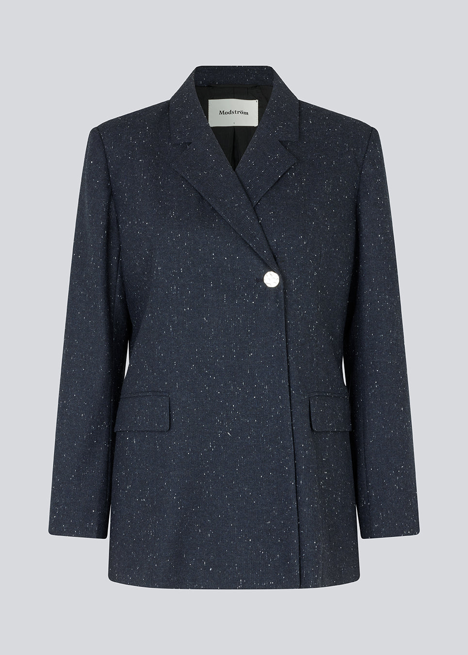 Oversized double-breasted blazer with a single visible button. FolaMD blazer is designed in a wool blend with small colored flecks. Part of set, buy the pants here: FolaMD pants. The model is 175 cm and wears a size S/36.