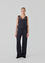 Satin top with a soft drape. FuniMD top is detailed with lacing on the straps and neckline in front and back. The model is 175 cm and wears a size S/36.