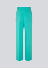 Gale pants in turquoise have a classic design. The pants have straight, wide legs with press folds, which creates an elegant look. The model is 175 cm and wears a size S/36.  Shop matching blazer: Gale blazer.