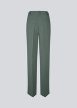 Gale pants in dark green have a classic design. The pants have straight, wide legs with pressfolds, which create an elegant look. The model is 175 cm and wears a size S/36.