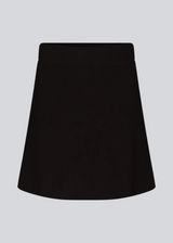 Knitted mini skirt in black in an A-line silhouette with a high waist with covered elasticated. GalenMD skirt is made of organic cotton. 