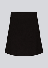 Knitted mini skirt in black in an A-line silhouette with a high waist with covered elasticated. GalenMD skirt is made of organic cotton.