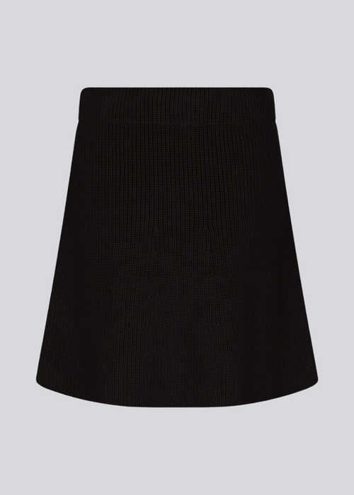 Knitted mini skirt in black in an A-line silhouette with a high waist with covered elasticated. GalenMD skirt is made of organic cotton. 