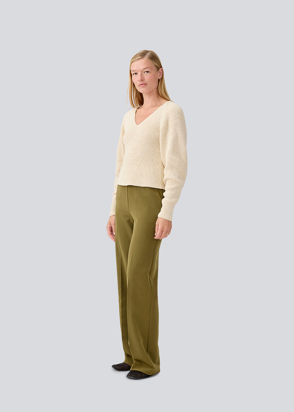 Fitted knit in organiccotton. GalenMD short v-neck is in a creme color, has long vide sleeves and a v-neck. The model is 177 cm and wears a size S/36.