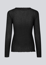 GeniferMD top is made in a slightly transparent quality with a tight fit. The top has long sleeves and a semi-high neckline with lettuce hems.