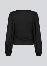 HarlandMD top in black has a regular fit in a woven quality with a v-shaped neckline in front, and long balloon sleeves with elasticated cuff. The model is 175 cm and wears a size S/36.