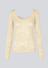 Tight-fitting top in beige in a stretchy lace material, that is slightly see-through. HawkinsMD top has long sleeves, and a deep neckline in front and back.