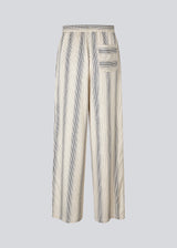 Pants with a relaxed shape. HissaMD print pants has wide legs and a high waist with covered elastication and tiebands. Side pockets and a patch back pocket