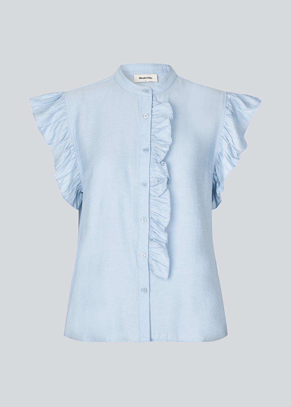 HolidayMD top in light blue is designed with a standing collar and button closure in front. The top has a frilly detail along the placket and at the armholes. The model is 175 cm and wears a size S/36.