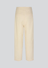 Pants with straight legs in a structured material. HollisMD pants have a medium waist with hidden zipper at one side, and two welt pockets on the back. 