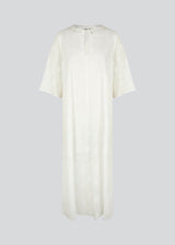 Broderie anglaise cotton dress in white with a casual fit and wide sleeves cutting at the elbow, and a opening in front with a tieband. HollynMD dress is lined. The model is 175 cm and wears a size S/36.