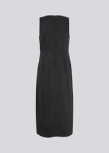 Dress in black with a slim silhouette, round neck, and without sleeves. HomerMD dress has an elegant look with a cutline mid front and back, and a high slit in front. Hidden zipper in the back. The model is 175 cm and wears a size S/36.