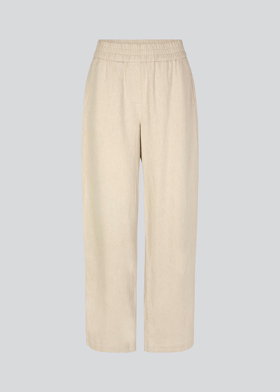 Pants in beige designed with a casual look and fit in a cotton and linen blend. HonorMD pants has loose legs and a medium waist with a wide elastic band. The model is 175 cm and wears a size S/36.