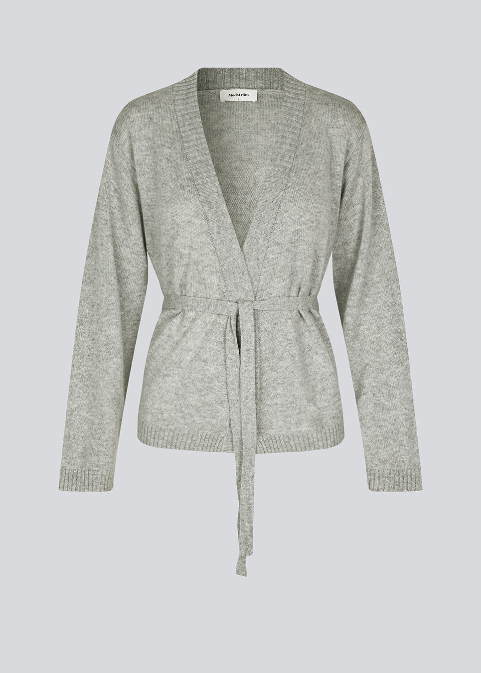Loose knitted cardigan in 100% mercerized wool. HowieMD cardigan has a tie band in the waist and long loose sleeves.